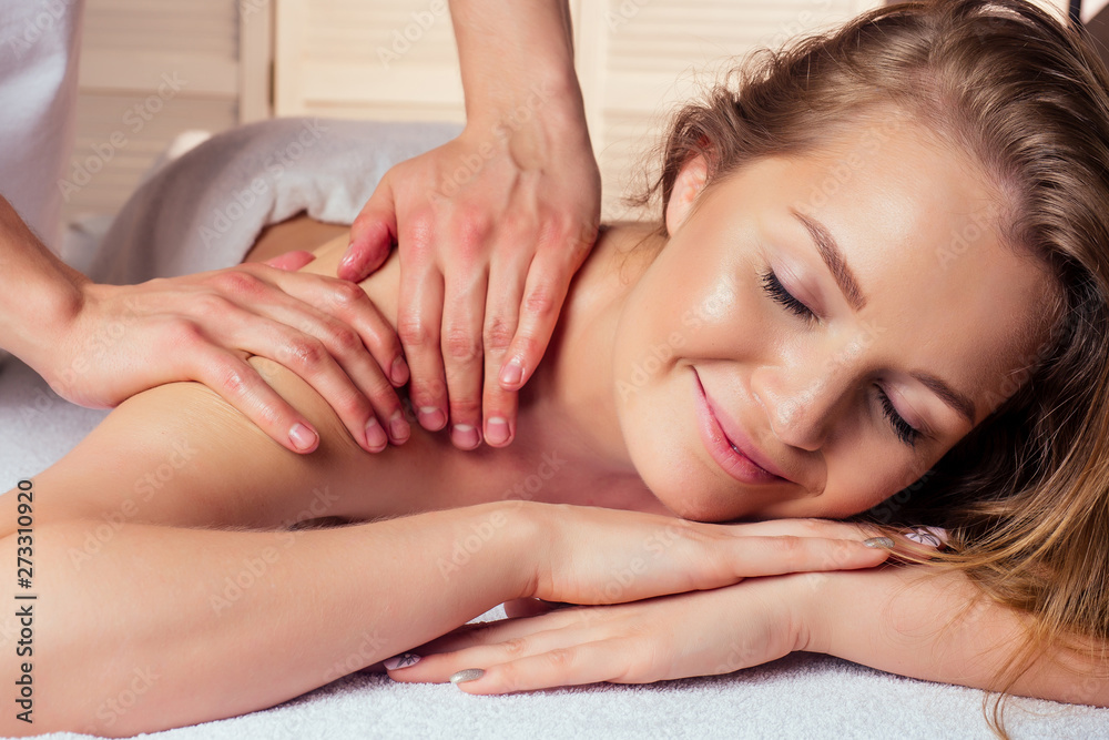 closeup beautiful young woman close eyes getting back massaging closeup beautiful young woman close eyes getting back massaging