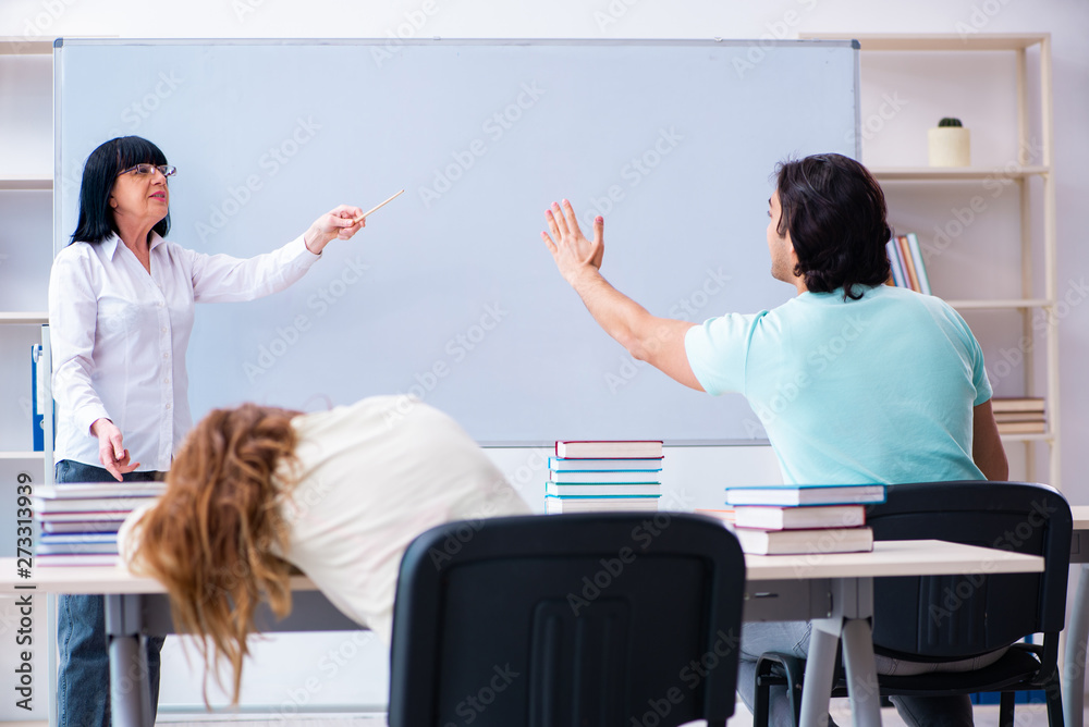 Old teacher and students in the classroom 