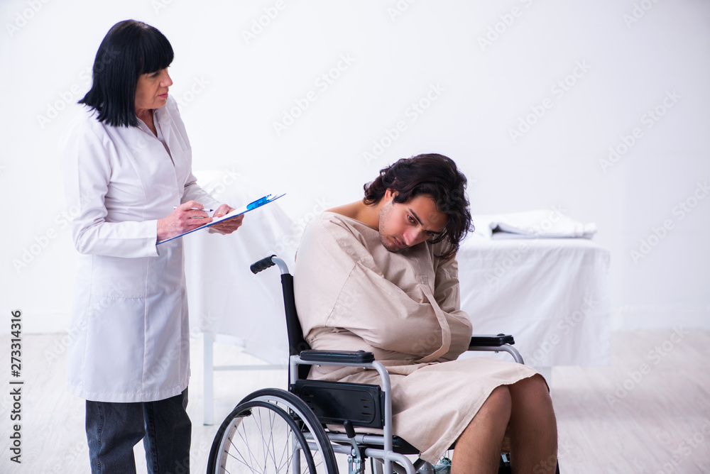 Old female psychiatrist visiting young male patient Old female psychiatrist visiting young male patient