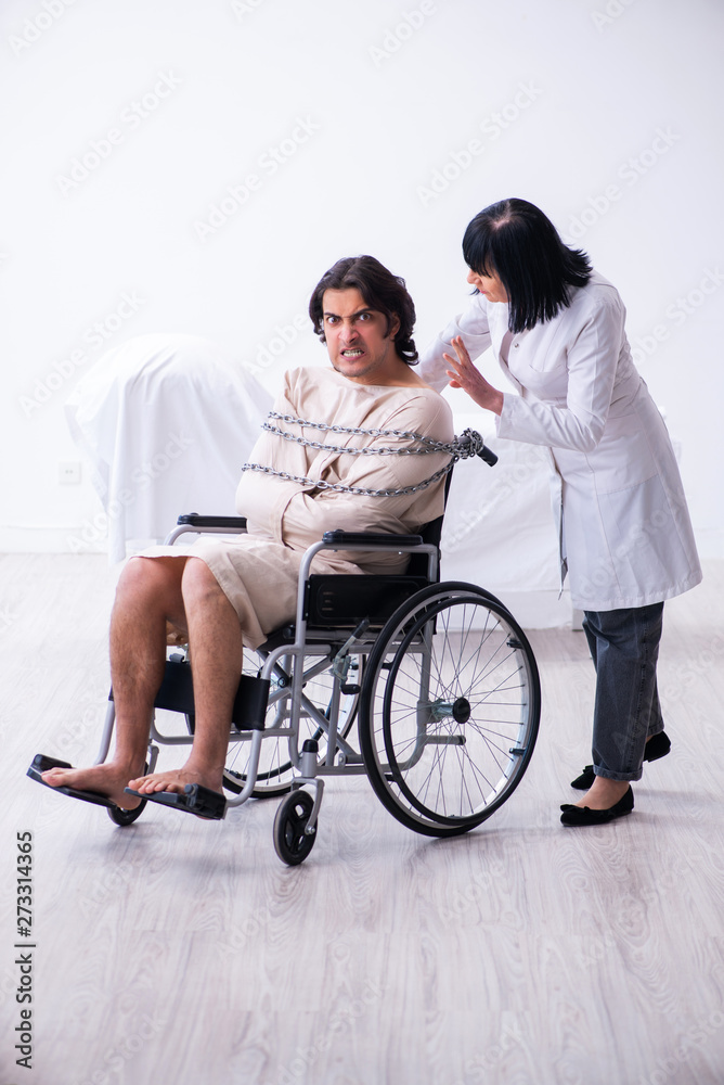 Old female psychiatrist visiting young male patient Old female psychiatrist visiting young male patient