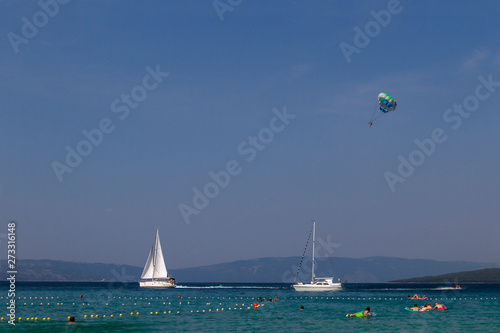 Croatian beach at a sunny day. Sport and ocean activity on beach holiday. Adriatic sea .Summer vacation. Concept of summer adventures, holidays, active summer holidays .