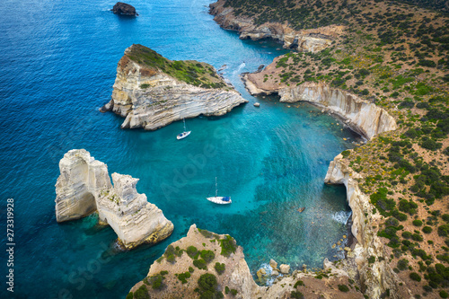 Fototapeta Naklejka Na Ścianę i Meble -  aerial view to curved rock bay with giant rocks and two yachts in Greece