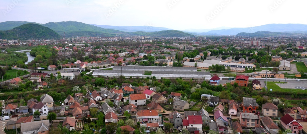 Panoramic picture of the city, houses, mountains, river.