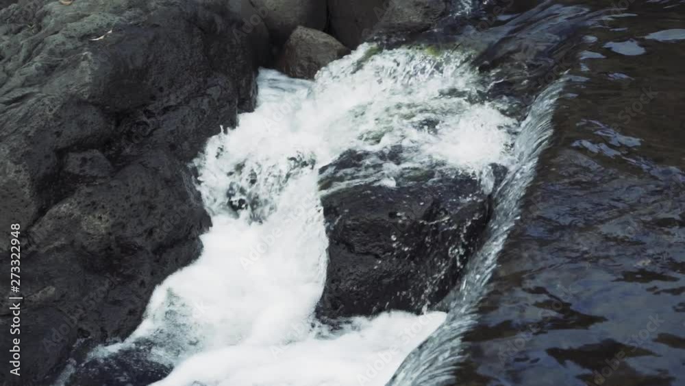 BEAUTIFULLY COMPOSED SHOT OF WATER FLOWING OVER THE EDGE OF A BRIDGE BEAUTIFULLY COMPOSED SHOT OF WATER FLOWING OVER THE EDGE OF A BRIDGE