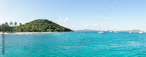 Tropical ocean and beach with sail boat yacht in the Tobago Cays, Saint Vincent and the Grenadines, Caribbean. photo