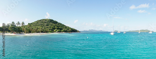 Tropical ocean and beach with sail boat yacht in the Tobago Cays, Saint Vincent and the Grenadines, Caribbean. photo
