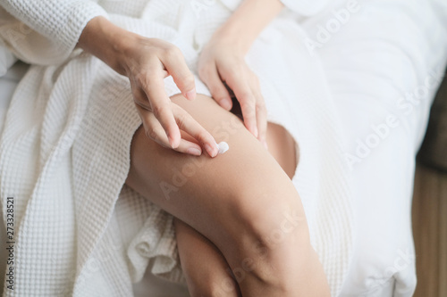 Woman applying legs cream,lotion , Hygiene skin body care concept.