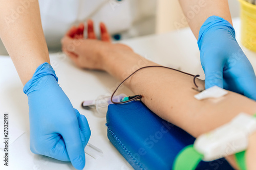 Biochemical analysis of blood in women. HIV test for a young girl. A blood sample from a vein for the test. Woman in the doctor's office photo