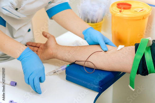 Biochemical analysis of blood in men. HIV test for a young guy. A blood sample from a vein for the test. The man in the doctor's office photo