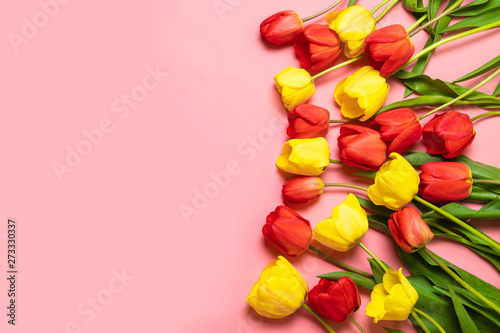 International Women on a pink  background. Red tulips on a pink background. Flat lay, top view. Greeting card 