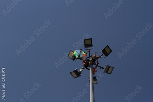 High lighting pole with strong LED lights and a kite attached to it