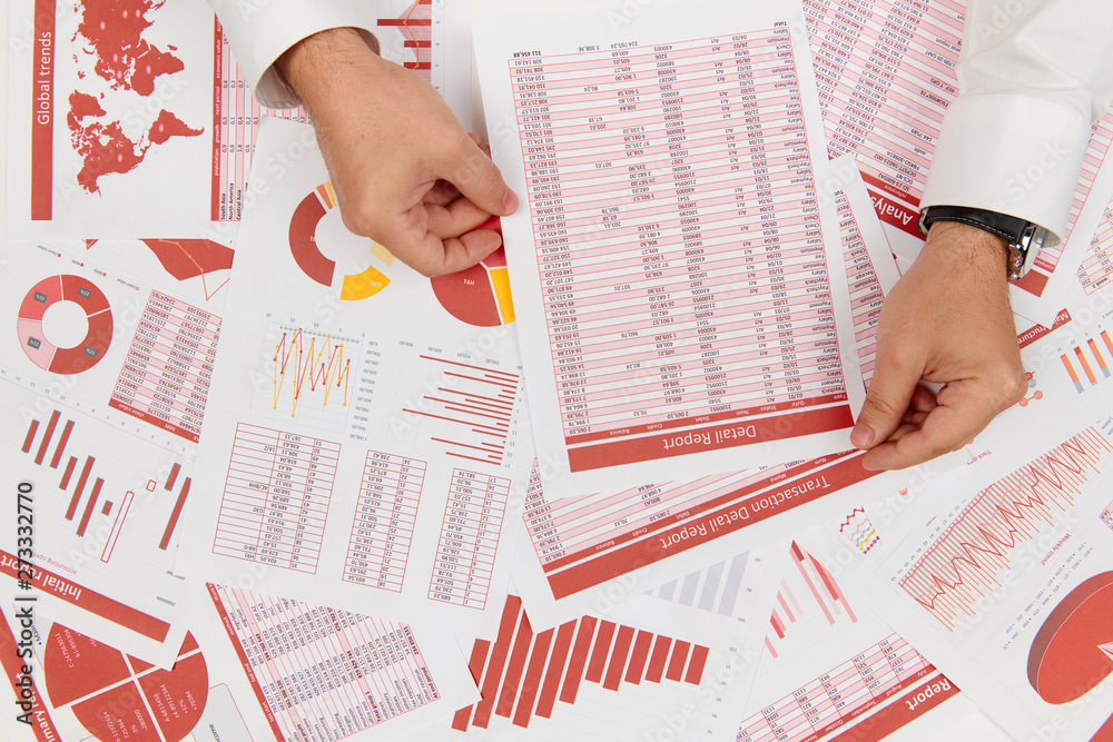 Obraz premium Flat top view of businessman working and calculating finance, reads and writes reports. Business financial accounting concept.