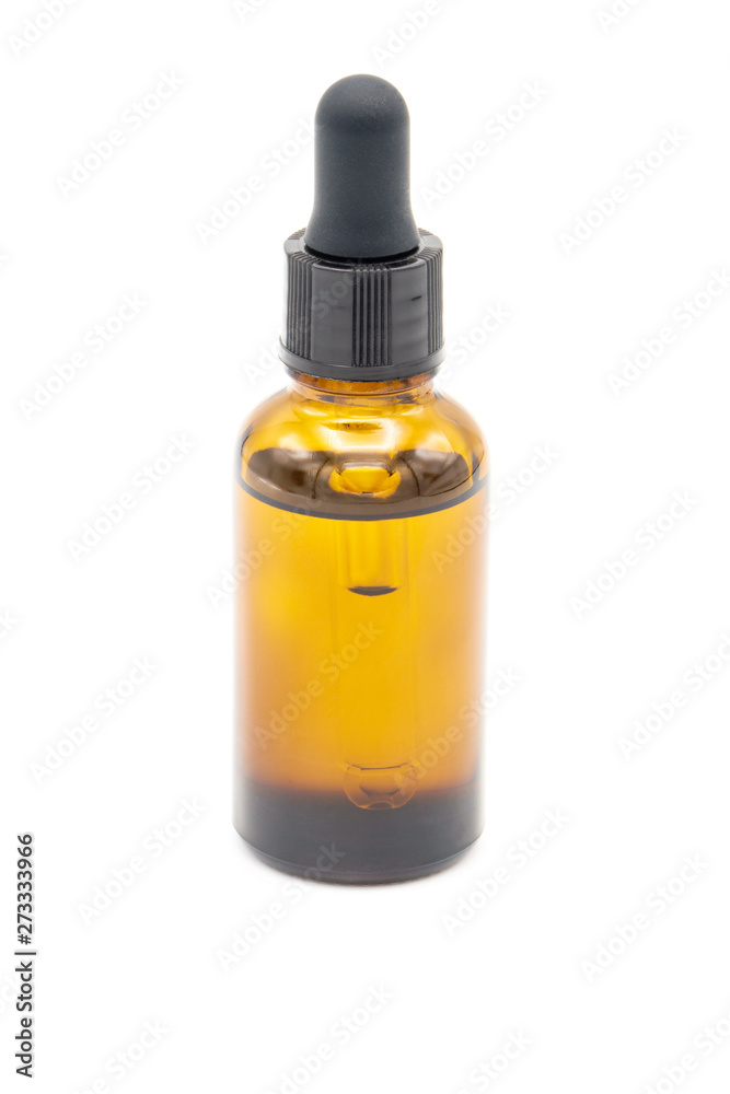 Brown glass bottle whit pipette on white background. Cosmetic and medical packaging concept. Mockup. Copy space Brown glass bottle whit pipette on white background. Cosmetic and medical packaging concept. Mockup. Copy space