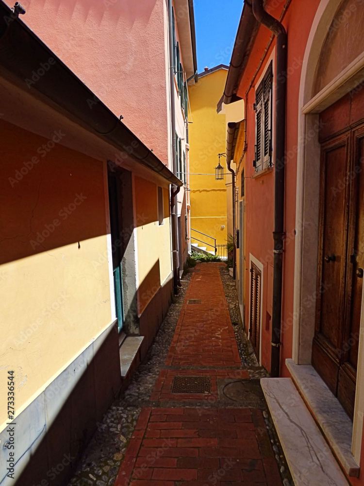 Narrow brightly colored street in Telaro, Italy a seaside town on the Italian Riveria.