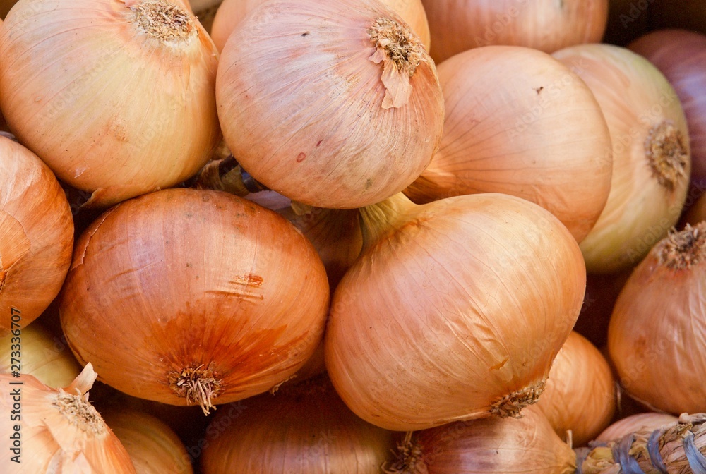 Pile of whole fresh onions on a food market in Portugal