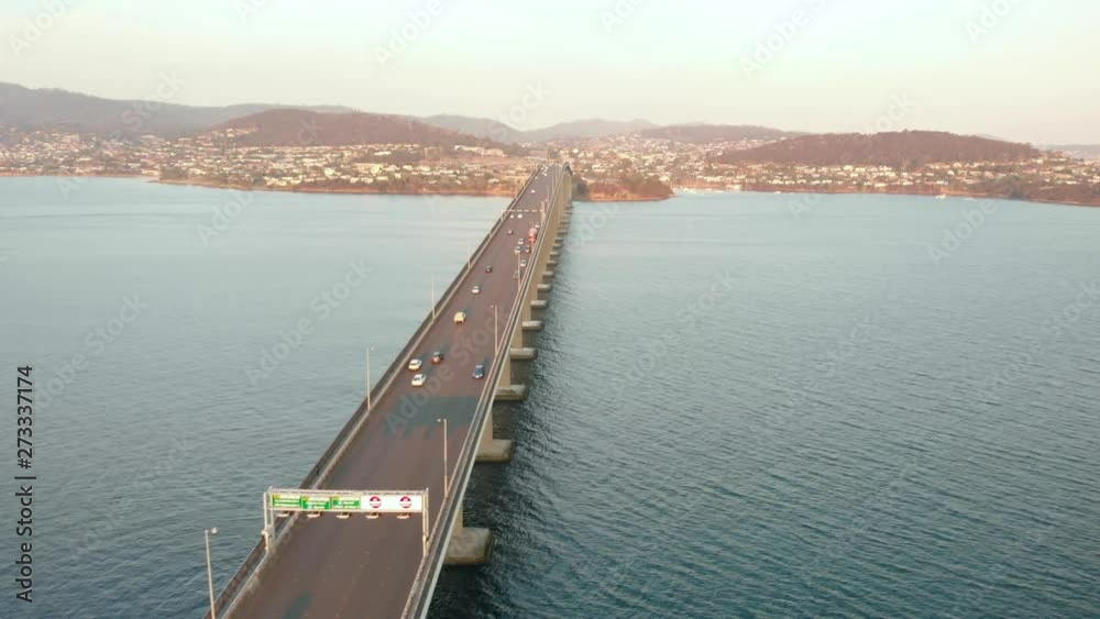 Aerial shot over Tasman bridge highway at sunset. (Drone footage) Aerial shot over Tasman bridge highway at sunset. (Drone footage)