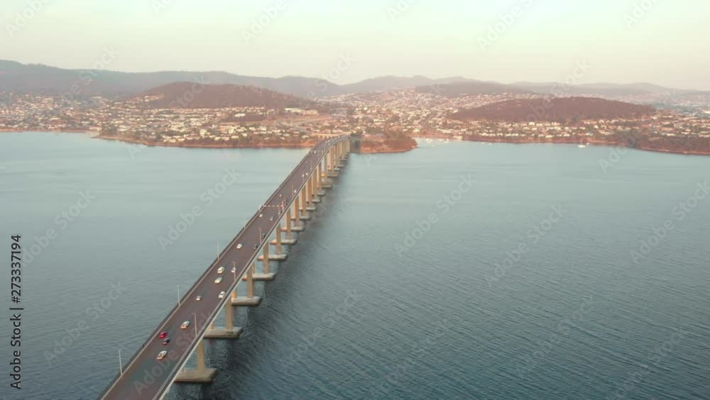 Hobart, Aerial shot over Tasman bridge highway at sunset. (Drone footage) Hobart, Aerial shot over Tasman bridge highway at sunset. (Drone footage)