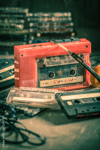 Closeup of antique audio cassette with walkman and headphones