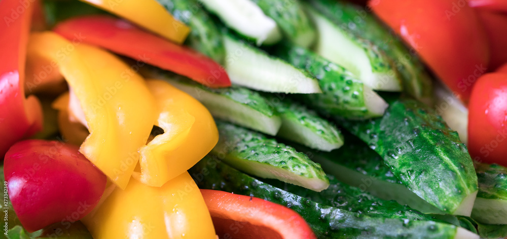 .slicing bell peppers cucumbers and tomatoes close up .slicing bell peppers cucumbers and tomatoes close up