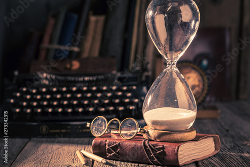 Hourglass and typewriter as memories of old journeys