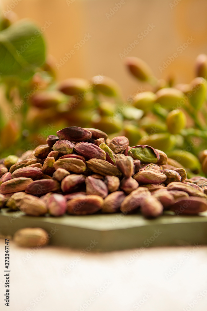 Fototapeta premium Sweet, delicate and fragrant nuts, Bronte pistachios with brilliant green colour, ingredient for Italian cuisine, ice creams, cakes, pesto