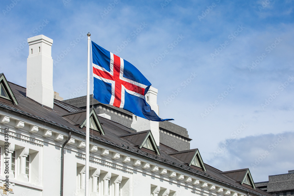 Iceland flag against summer sky. Reykjavik.