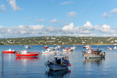 Seascape with sea harbor with clear blue water and traditional colorful greek fisher boats
