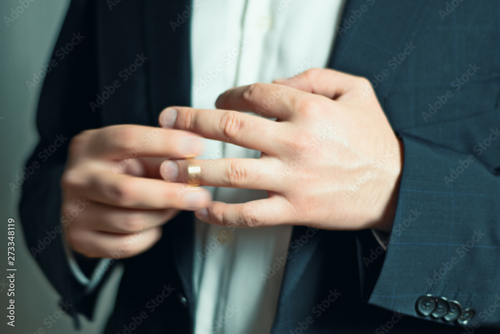 Business man taking  off or putting on his wedding ring
