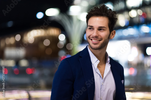Young businessman outdoor in a modern city setting at night
