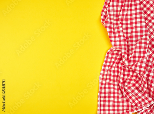 red kitchen towel in a cage on a yellow background