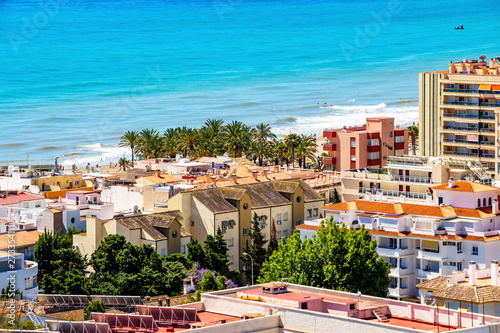 The Mediterranean Sea behind the buildings of Torremolinos, Province of Malaga, Andalusia, Spain, elevated view from the Parque de la Bateria observation tower photo