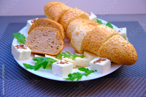 Fresh bread with cheese and basil for breakfast in a trip