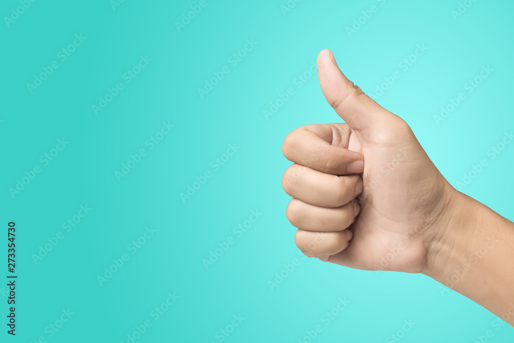Thumb up hand sign on pastel background.