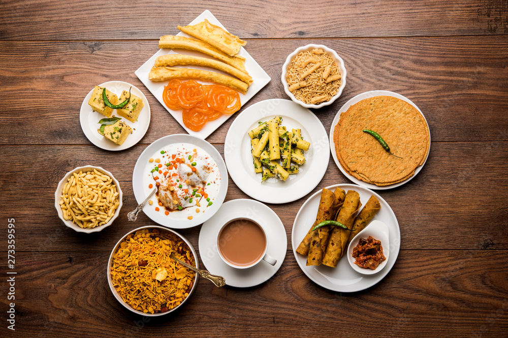 Group of Gujarati snacks like jalebi-fafda, thepla, khaman dhokla, aloo bhujiya, khandvi,khakra, dahi vada, gathiya with hot tea Group of Gujarati snacks like jalebi-fafda, thepla, khaman dhokla, aloo bhujiya, khandvi,khakra, dahi vada, gathiya with hot tea
