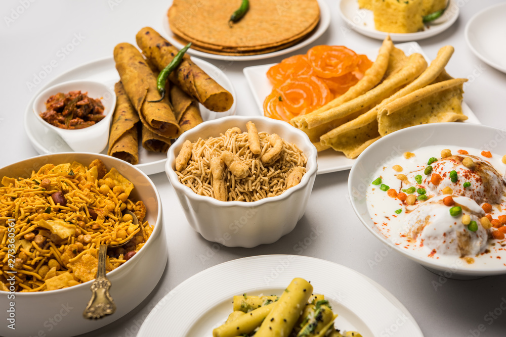 Group of Gujarati snacks like jalebi-fafda, thepla, khaman dhokla, aloo bhujiya, khandvi,khakra, dahi vada, gathiya with hot tea Group of Gujarati snacks like jalebi-fafda, thepla, khaman dhokla, aloo bhujiya, khandvi,khakra, dahi vada, gathiya with hot tea