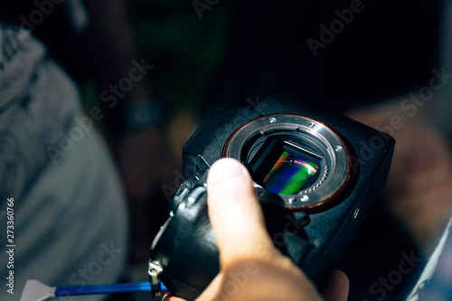 Cleaning the camera matrix from dirt. Remove dust from the photo sensor on the street. Quick camera repair photo