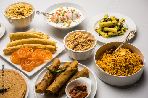 Group of Gujarati snacks like jalebi-fafda, thepla, khaman dhokla, aloo bhujiya, khandvi,khakra, dahi vada, gathiya with hot tea