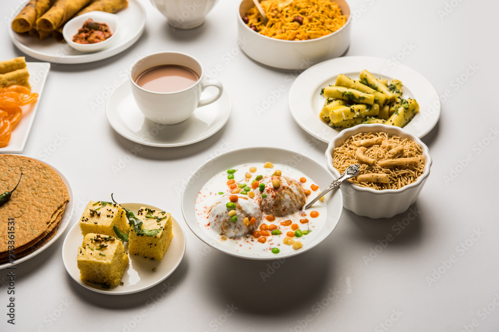 Group of Gujarati snacks like jalebi-fafda, thepla, khaman dhokla, aloo bhujiya, khandvi,khakra, dahi vada, gathiya with hot tea Group of Gujarati snacks like jalebi-fafda, thepla, khaman dhokla, aloo bhujiya, khandvi,khakra, dahi vada, gathiya with hot tea