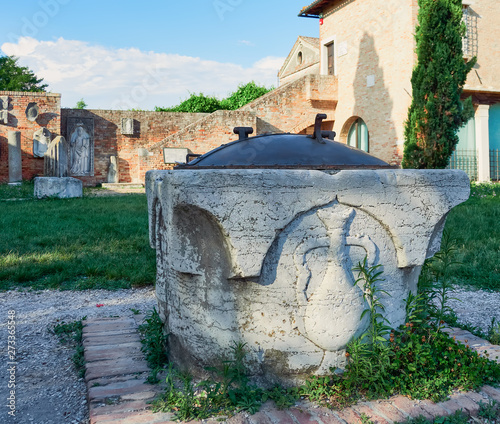 Ancient historical ruins in the area of ​​the church of Santa Fosca and the Cathedral Santa María Asunta de Torcello, on the island of Torcello, Venice, Italy photo