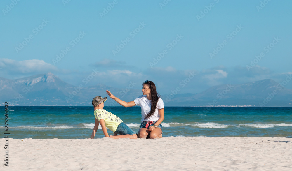 mom and son on the beach hugging play