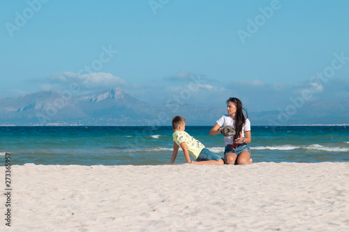 mom and son on the beach hugging play