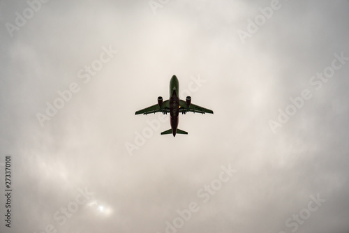Aircraft on a background of cloudy sky. Landing a liner close-up. Spring. Day.