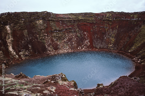 Kerid (Kerith) is a famous turquoise lake located in a volcanic creater and surrounded by magnificent hills of crimson red sand. Southern Iceland photo