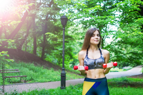 Fitness sport girl in fashion sportswear doing youga fitness exercise in the street, park, outdoor sports, urban style photo