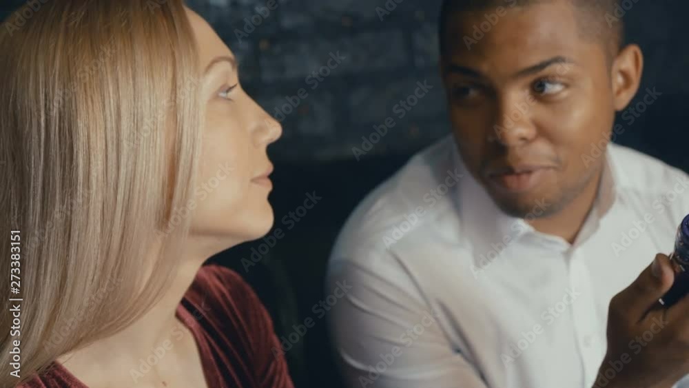 Multicultural happy people meet in cafe and comunicate, african and caucasian people talking at coffee shop, drinking coffee and smoking vape. Multicultural happy people meet in cafe and comunicate, african and caucasian people talking at coffee shop, drinking coffee and smoking vape.