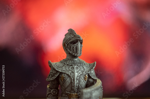 Gray figure of a medieval knight on a bloody background