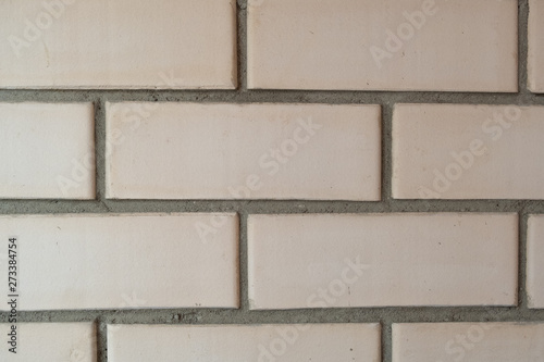 Light brown brick background. Beige wall.