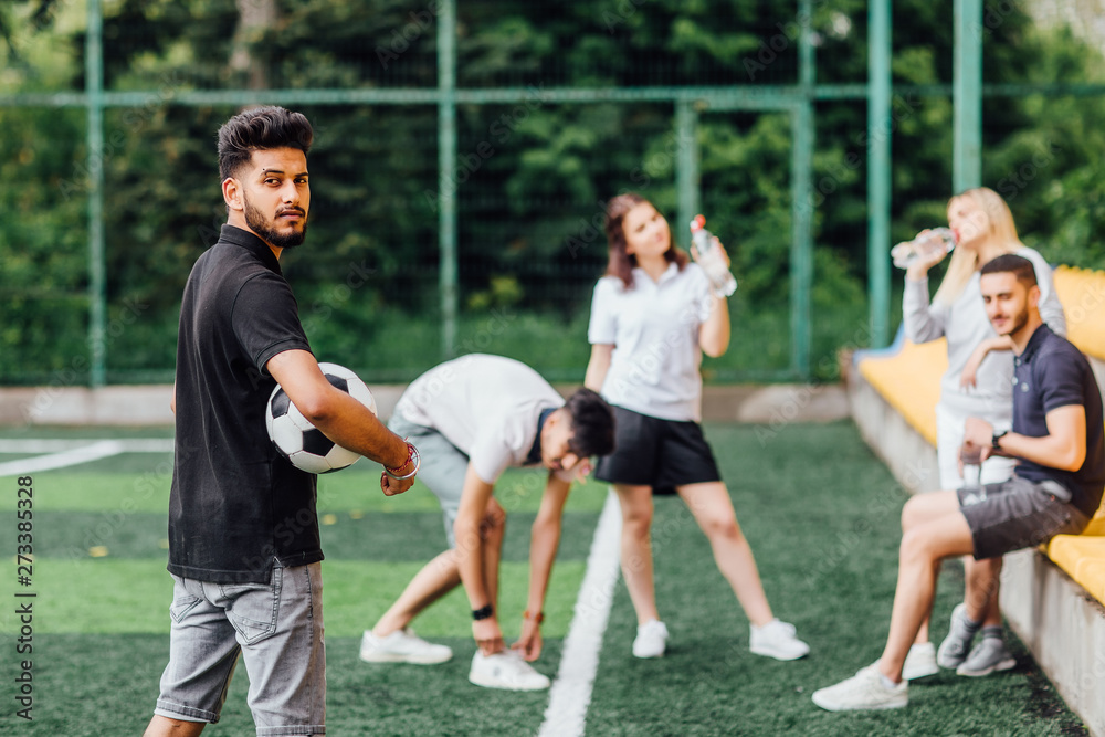Photo of athletic african american soccer player staying with ball on green field. Photo of athletic african american soccer player staying with ball on green field.