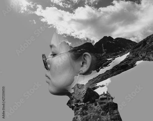 Black and white double exposure combined photographs with the Asian young woman wearing retro sunglasses and mountains.