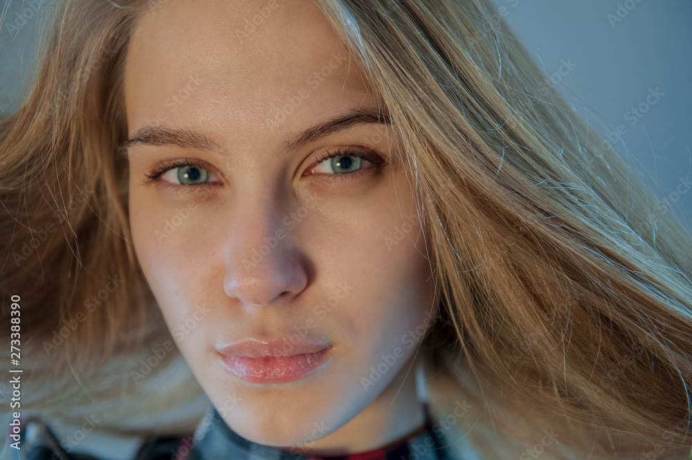 beautiful blonde with blue eyes in plaid dress touches her hair. Young actress shows acting exercises. woman actively expresses her emotions and poses for camera beautiful blonde with blue eyes in plaid dress touches her hair. Young actress shows acting exercises. woman actively expresses her emotions and poses for camera